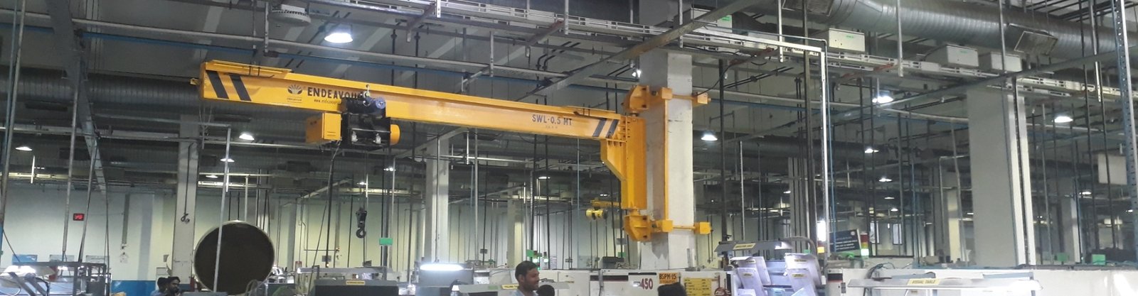 Jib crane in an industrial setting, showcasing its ability to lift and move heavy materials efficiently.
